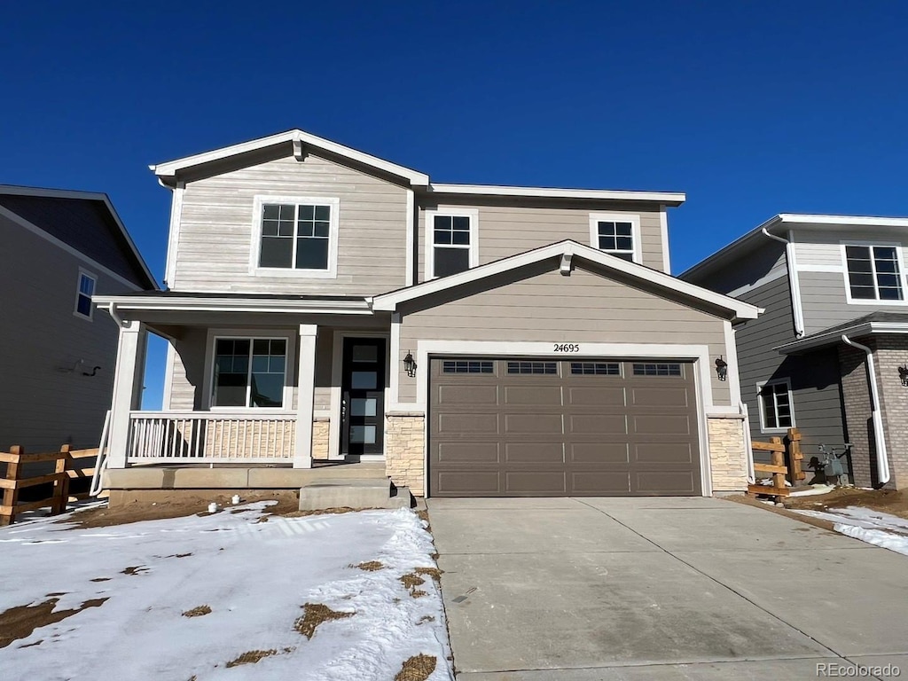 view of front of home featuring covered porch and a garage