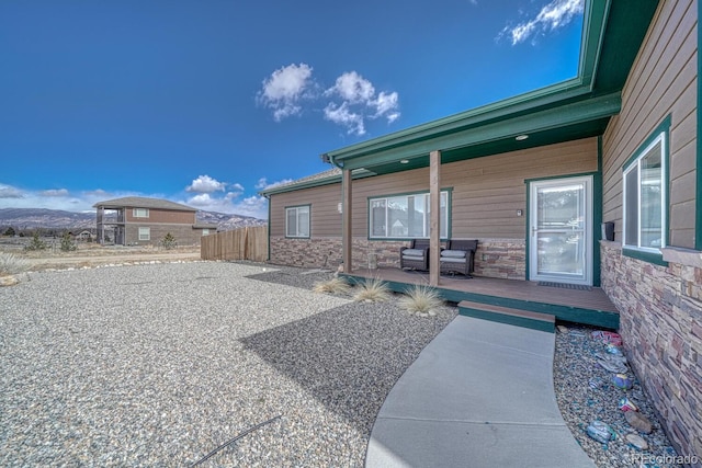 exterior space featuring fence and a mountain view