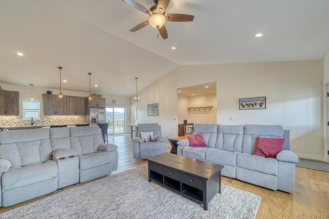 living room with ceiling fan, light wood-style flooring, recessed lighting, baseboards, and vaulted ceiling