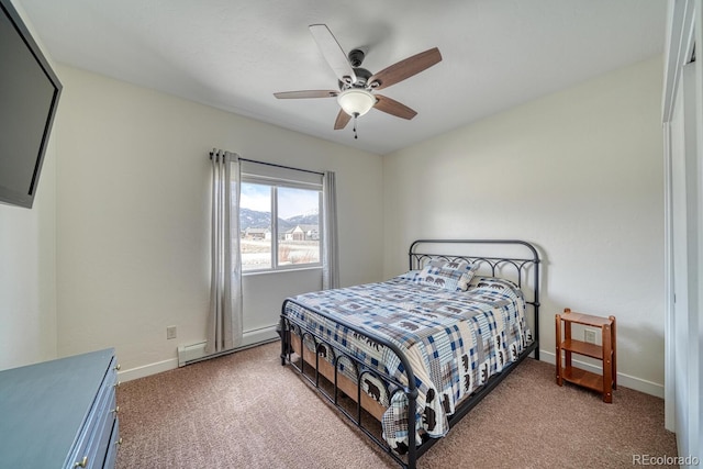 carpeted bedroom with ceiling fan, baseboards, and baseboard heating