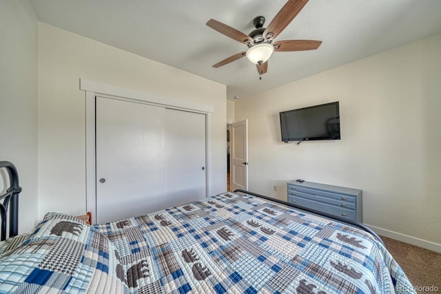 bedroom with carpet, a closet, ceiling fan, and baseboards