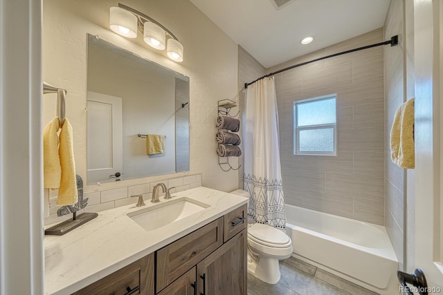 full bathroom with toilet, tile patterned flooring, shower / bath combo with shower curtain, and vanity