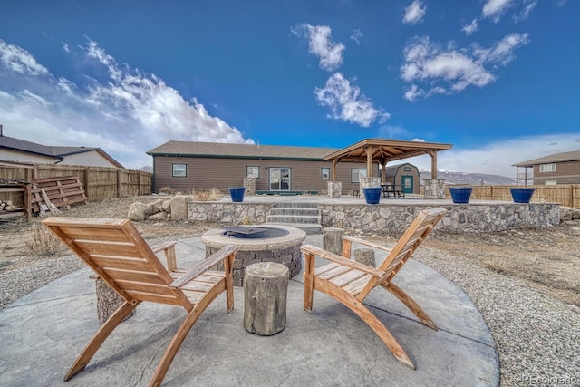 view of patio featuring a gazebo, an outdoor fire pit, and a fenced backyard