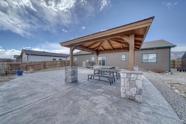 view of patio / terrace with a gazebo, outdoor dining space, and fence