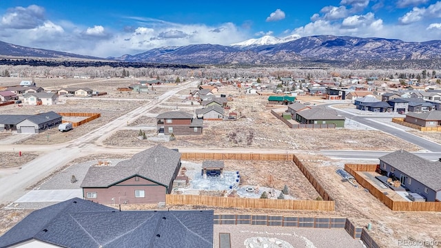 drone / aerial view featuring a residential view and a mountain view