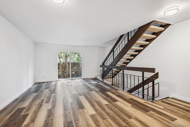 unfurnished living room featuring hardwood / wood-style flooring