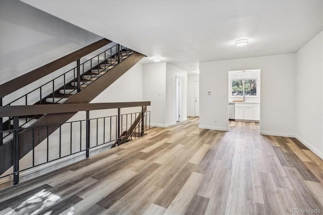 bonus room with light wood-type flooring