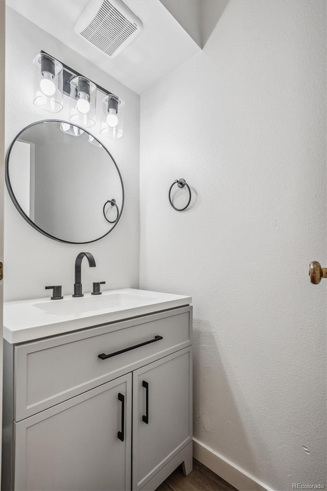 bathroom featuring vanity and wood-type flooring