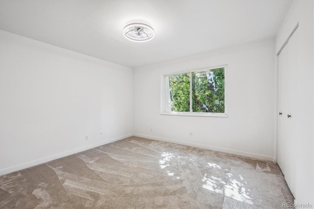 unfurnished room featuring light colored carpet