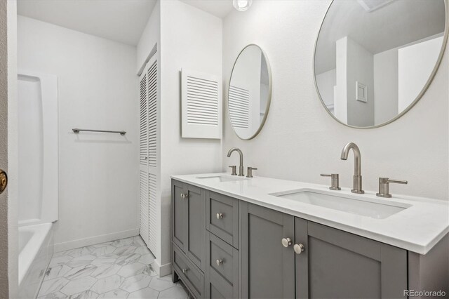 bathroom with vanity and a washtub