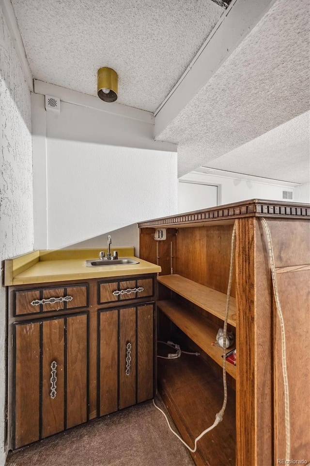 interior space featuring a textured ceiling and sink