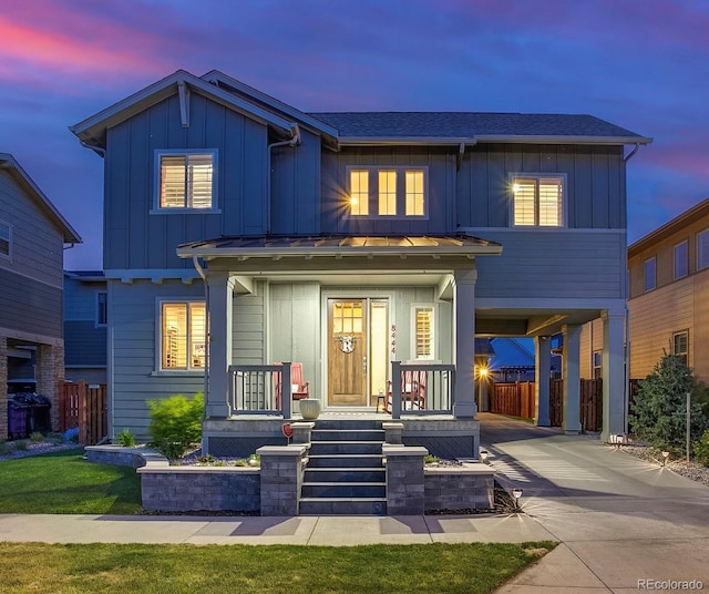 8444 E 55th Pl, Denver, CO 80238 - view of front of property featuring a standing seam roof, board and batten siding, metal roof, driveway, and a carport