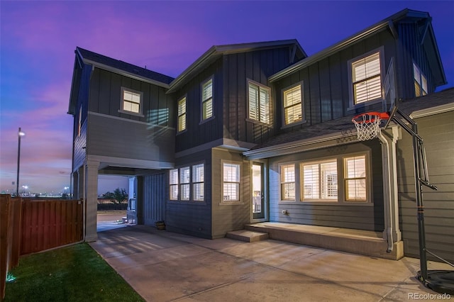 8444 E 55th Pl, Denver, CO 80238 - back of house at dusk with board and batten siding and fence