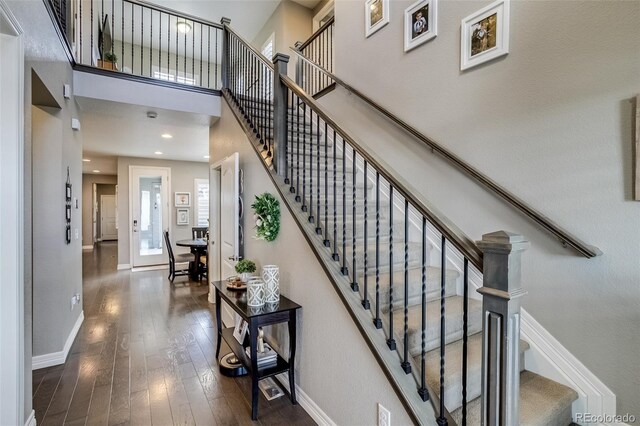 8444 E 55th Pl, Denver, CO 80238 - stairs with baseboards, wood-type flooring, and a towering ceiling