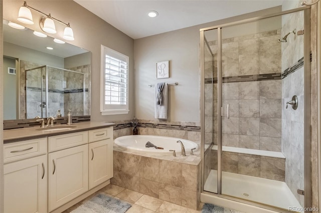 8444 E 55th Pl, Denver, CO 80238 - bathroom featuring a garden tub, vanity, visible vents, tile patterned floors, and a shower stall