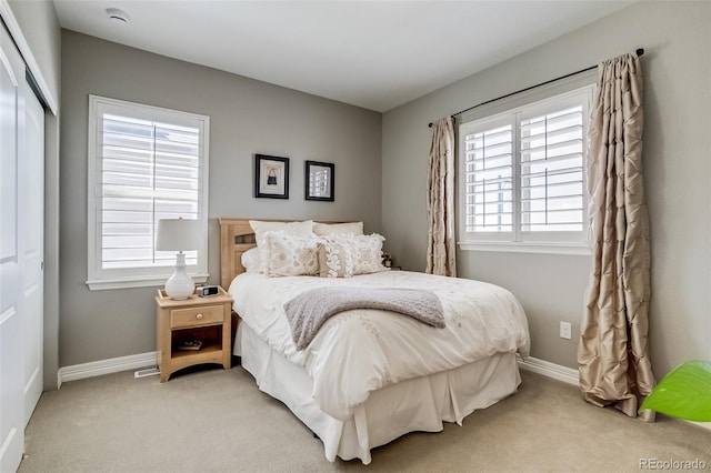 8444 E 55th Pl, Denver, CO 80238 - bedroom featuring baseboards, light carpet, and a closet