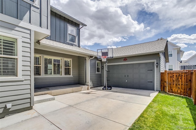 8444 E 55th Pl, Denver, CO 80238 - rear view of property with fence, board and batten siding, concrete driveway, and a garage