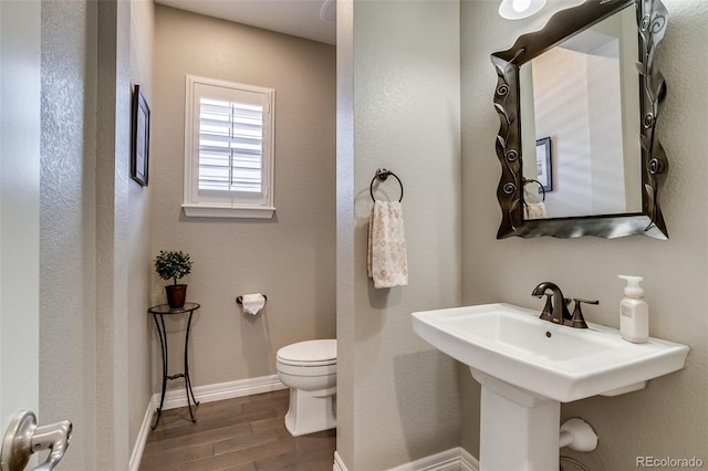 8444 E 55th Pl, Denver, CO 80238 - half bathroom with wood finished floors and toilet