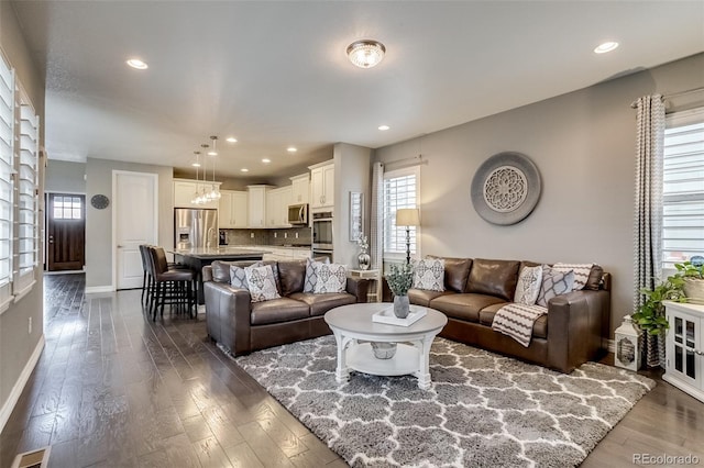 8444 E 55th Pl, Denver, CO 80238 - living area featuring healthy amount of natural light, dark wood finished floors, and recessed lighting