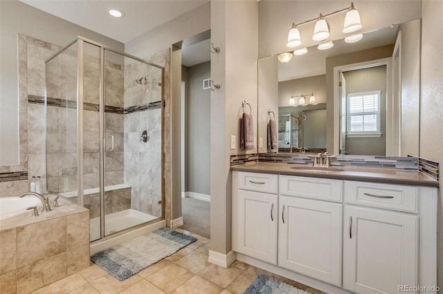 8444 E 55th Pl, Denver, CO 80238 - bathroom with a stall shower, a bath, vanity, and tile patterned flooring
