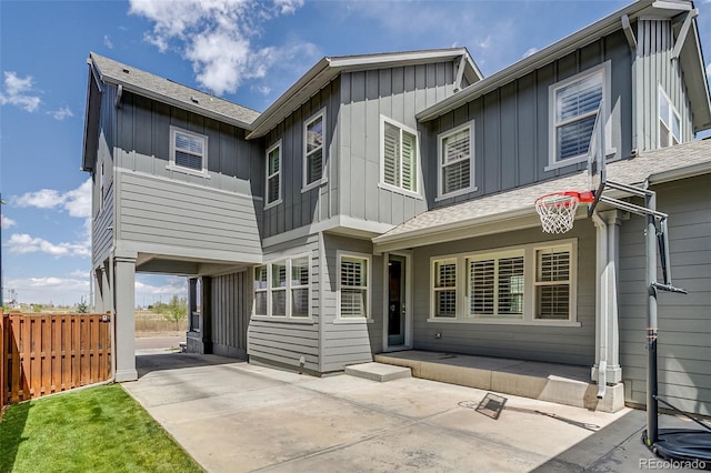 8444 E 55th Pl, Denver, CO 80238 - back of house featuring board and batten siding, concrete driveway, and a shingled roof