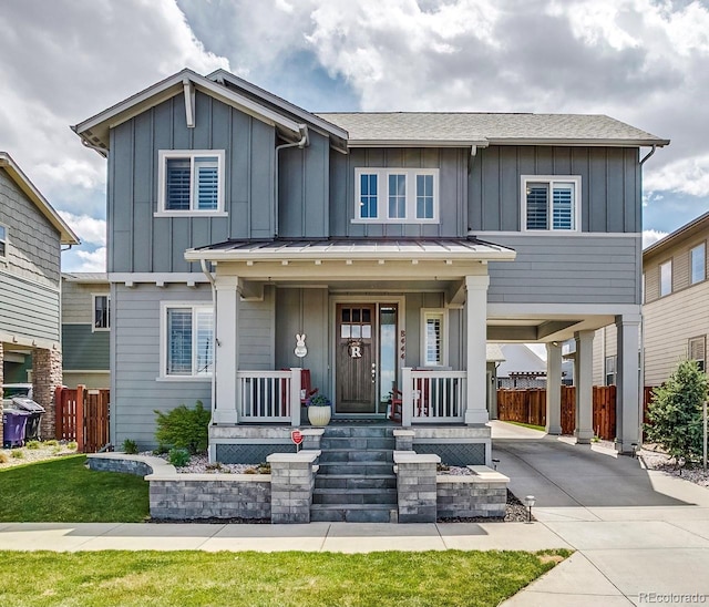 8444 E 55th Pl, Denver, CO 80238 - view of front of home featuring board and batten siding, driveway, a carport, a porch, and a shingled roof