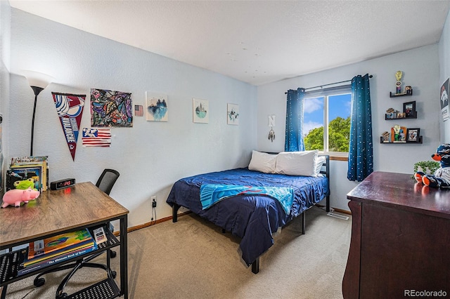 12261 N Holly Way, Brighton, CO 80602 - bedroom with light colored carpet, baseboards, and a textured wall