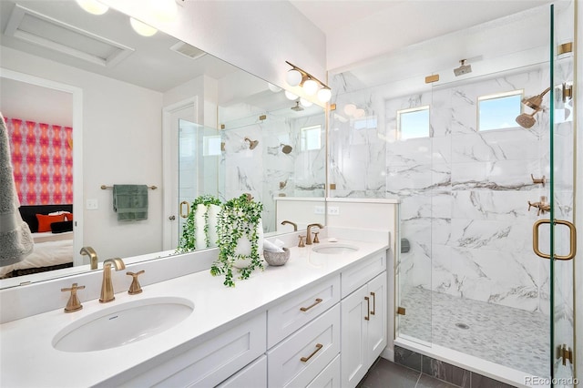 bathroom featuring a shower with door and vanity