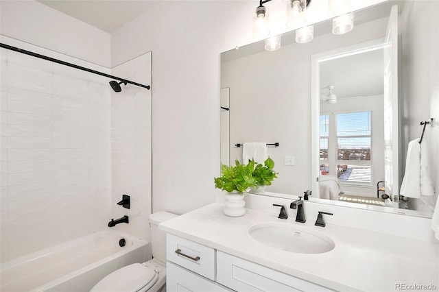 full bathroom with tiled shower / bath combo, vanity, and toilet