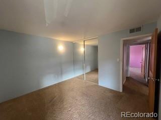 unfurnished bedroom featuring carpet floors and a closet