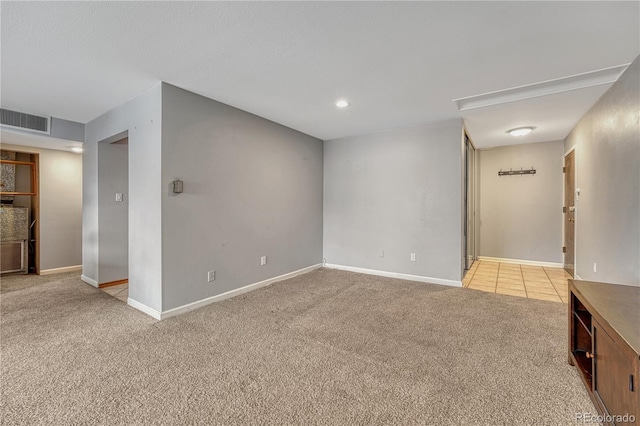 unfurnished room featuring light carpet, baseboards, and visible vents