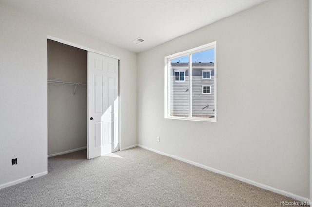 unfurnished bedroom with carpet flooring and a closet