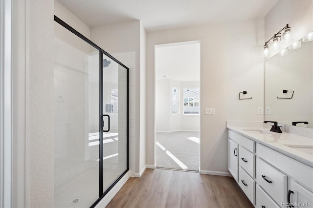 bathroom featuring vanity, wood-type flooring, and walk in shower