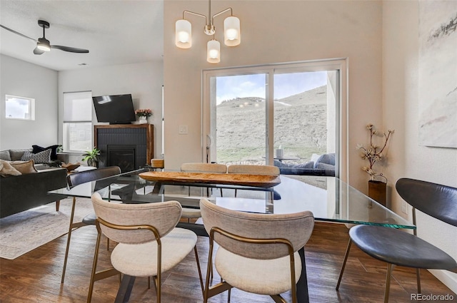 dining room featuring dark wood-type flooring and ceiling fan with notable chandelier