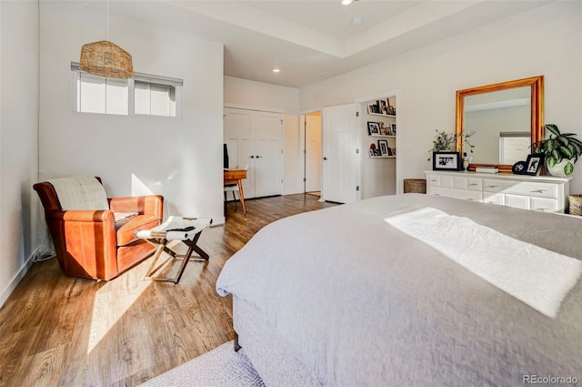 bedroom featuring hardwood / wood-style floors and a closet