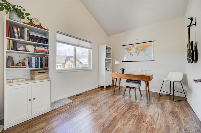 office area featuring light wood-type flooring and vaulted ceiling