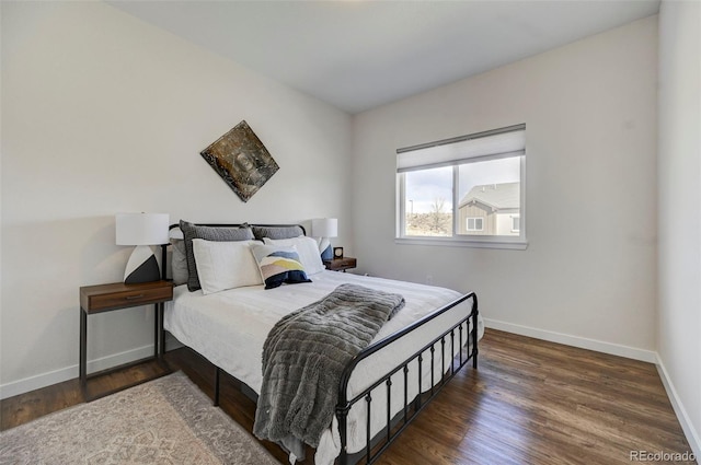 bedroom with dark hardwood / wood-style flooring