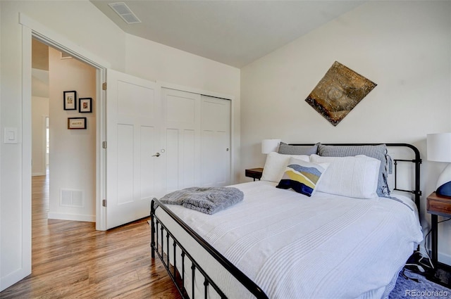 bedroom with light hardwood / wood-style flooring and a closet