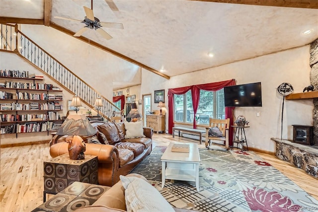 1361 Bross Ct, Evergreen, CO 80439 - living area with wood finished floors, a ceiling fan, stairs, and high vaulted ceiling