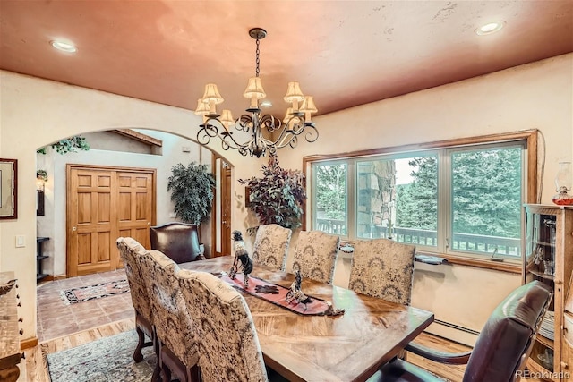 1361 Bross Ct, Evergreen, CO 80439 - dining room with arched walkways, a chandelier, and recessed lighting