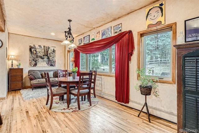 1361 Bross Ct, Evergreen, CO 80439 - dining space with wood finished floors, a baseboard radiator, and recessed lighting