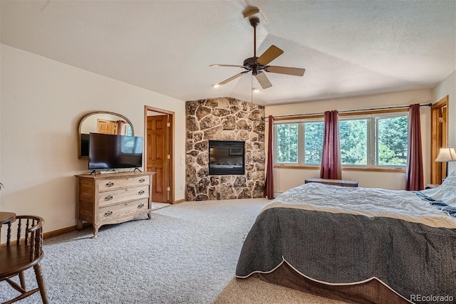1361 Bross Ct, Evergreen, CO 80439 - bedroom featuring carpet floors, lofted ceiling, a fireplace, a ceiling fan, and a textured ceiling
