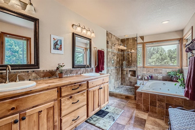 1361 Bross Ct, Evergreen, CO 80439 - full bath featuring a stall shower, a tub with jets, double vanity, a textured ceiling, and stone finish flooring
