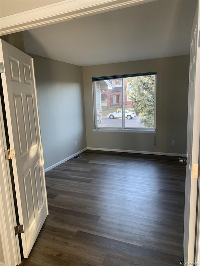 unfurnished room featuring dark hardwood / wood-style flooring