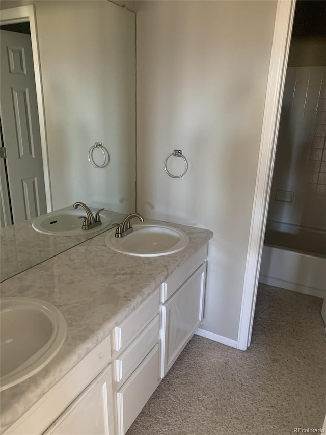 bathroom featuring vanity and  shower combination