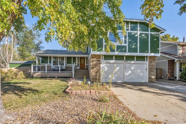 view of front facade with concrete driveway, brick siding, and a front lawn