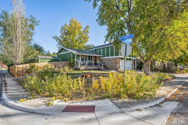 mid-century modern home with a sunroom and fence