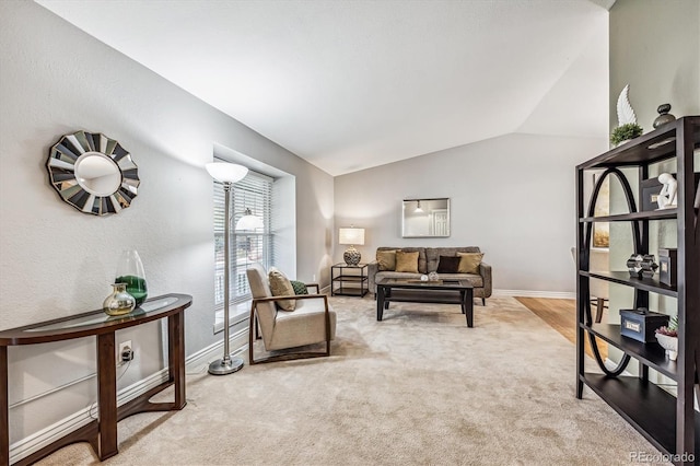 living area with lofted ceiling, carpet, and baseboards