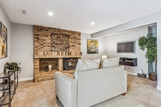 living room with light carpet, a fireplace, visible vents, and baseboards