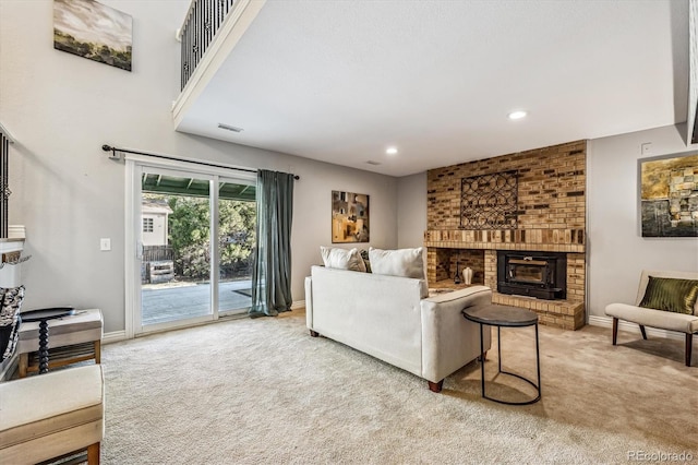 living room with recessed lighting, light carpet, a fireplace, visible vents, and baseboards